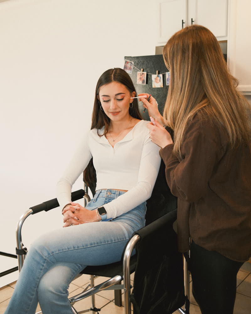 Bethany applying makeup for a client